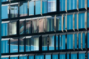 Reflection Of Man's Face On Glass Windows