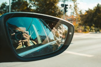 Reflection of Man Taking Pictures