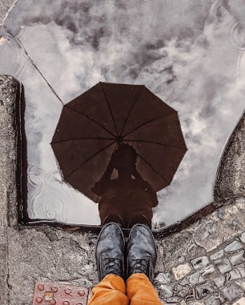 Reflection of Person Holding Umbrella