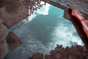 Reflection Of Sky From Puddle