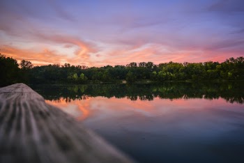 Reflection Of Sky On Lake Water During Golden Hour