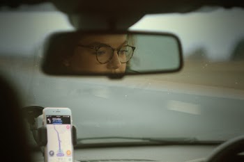 Reflection of Woman Driving Car