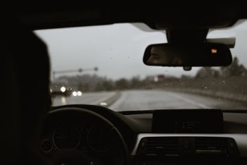 Reflection Photo of Man Driving a Car