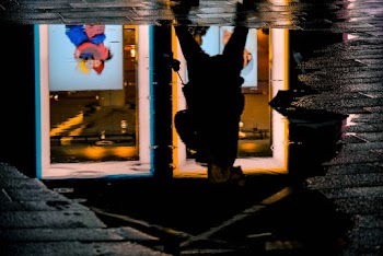 Reflection Photo of Person Standing on Pavement