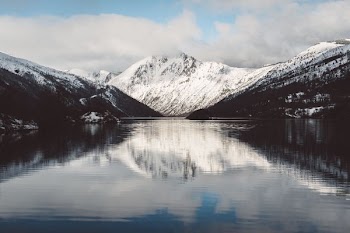 reflective photography of snow-covered mountain