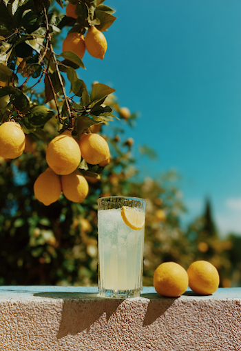 Refreshing Lemonade with Fresh Lemons Under a Blue Sky