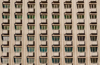 Regular rows of tiny balconies on an old apartment building