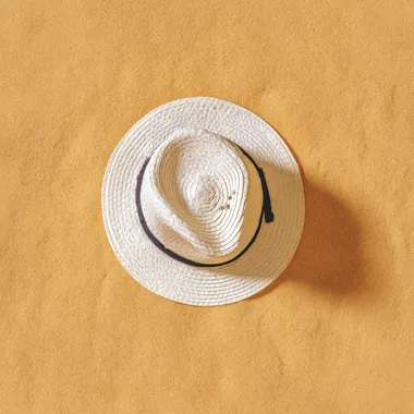 Relaxing Beach Vacation: White Hat on Sand Relaxing Beach Vacation: White Hat on Sand