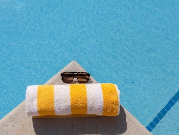 Relaxing by the Poolside with Towel and Sunglasses
