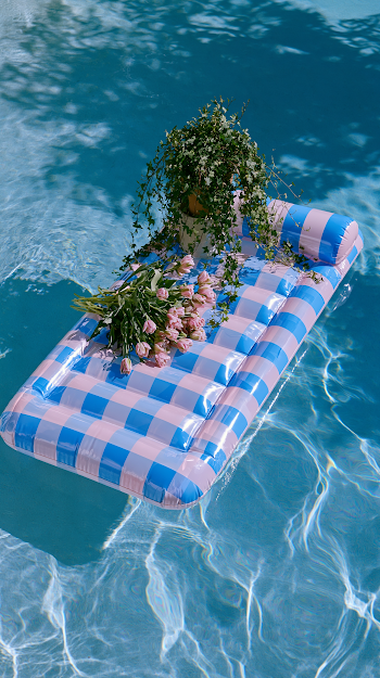 Relaxing Summer Vibes: Inflatable Mattress in a Blue Pool