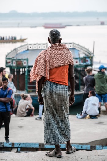 religious man in plaid fabrics at the Ganges River, Varanasi India