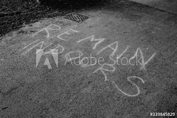 Remain indoors written on the road during coronavirus pandemic.