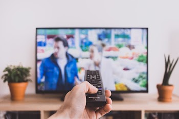 Remote control pointed at a TV screen