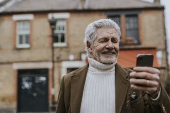 Retired man checking phone outdoors | Free Photo - rawpixel