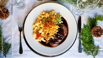 Rinderlende mit Röstzwiebeln Zwiebelrostbraten mit Sauce und Spätzle in einem Wirtshaus Biergarten serviert