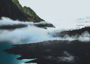Rinjani. Last week hike to this beautiful crater lake was quite intense. First day was rough. Nine hours of hike with both legs cramped the whole path. Not sure if it is because I'm out of shape by now, or is it my backpack that was too heavy. Or am I just getting old?

Second day was better though. That was another 6 hours hike until we finally reach Plawangan, where I took this picture. Literally cried when I saw the lake. It was magnificent. The scale is insane.

We were walking under the rain most of the day on the third day. I already had a feeling that there might be flood in one of the four rivers that we crossed. That's exactly what happened. Thankfully the water was still less than half of my height so getting across was still possible.

Overall this hike is one of the best and most scenic walk I ever did! And especially because I get to share this trip with one of my best friends.