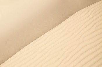 Ripples in the dry sands of a white air desert