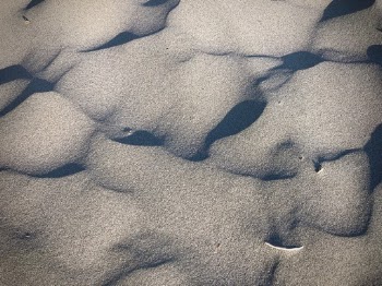 Ripples of black and tan sand formed by the waves and wind at Moonstone Beach in Trinidad, California.