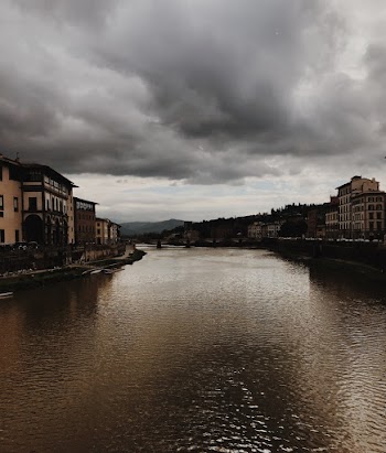 River Between Houses Under Dramatic Sky