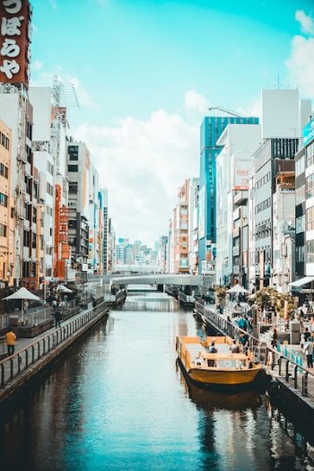river in between street and high rise buildings