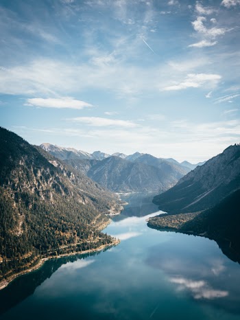 River in the Middle of Mountains during Day