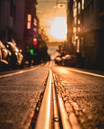Road Between Buildings during Sunset
