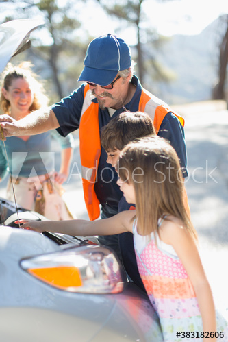Roadside assistance mechanic helping family with vehicle breakdown