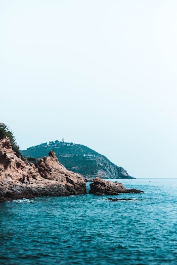 Rock Formation And Island On A Body Of Water