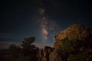 rock formation mountain under sky with stars