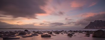 rock formation near shoreline during golden hour