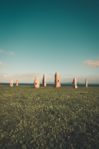Rock Formation on the Grass Field Photograph