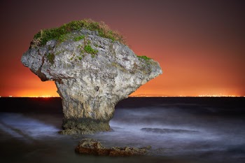 Rock Formation Surrounded By Body Of Water