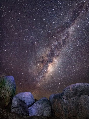 rock formation under starry sky