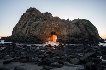 rock monolith beside body of water