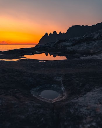 Rocks Near Body of Water during Golden Hour