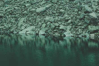Rocks Near Calm Body Of Water
