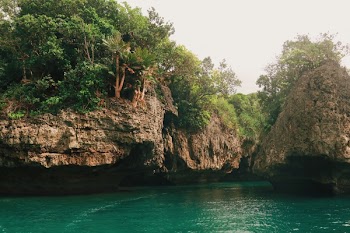 Rocky Cliff and Emerald Green Water View