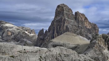 rocky cliff under cloudy sky