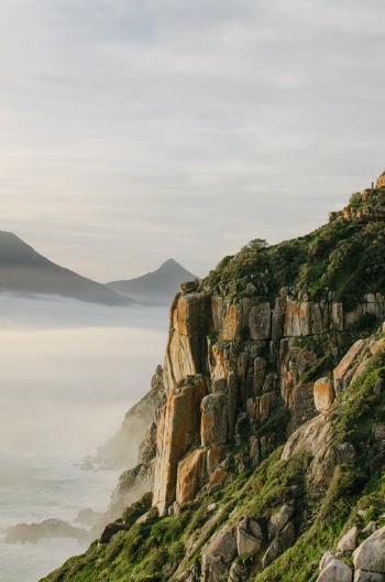 Rocky Cliff Under Cloudy Sky · Free Stock Photo