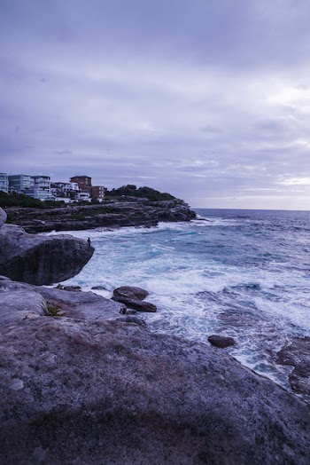 Rocky Coastline Under Gray Clouds