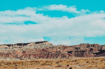 rocky mountain under cloudy sky