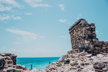 Rocky Terrain Near Sea Under Blue Skies
