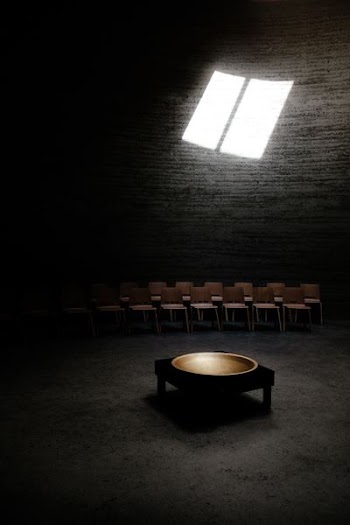 room with brown arranged chairs and black wooden table