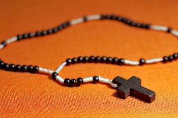 Rosary on Orange Surface