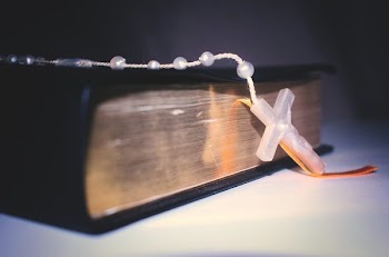 Rosary Resting On Bible