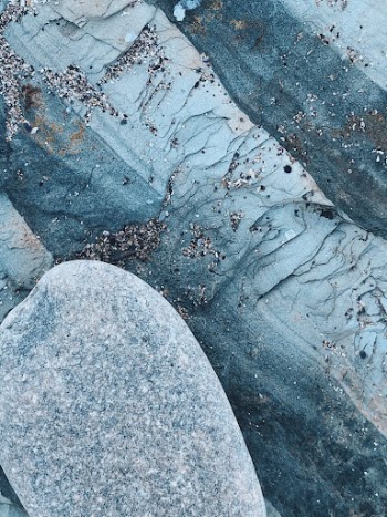 Rough frozen surface under old stone
