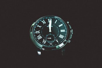 round black chronograph watch at 12:00