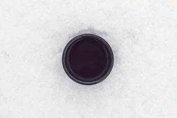 round black container on top of white surface