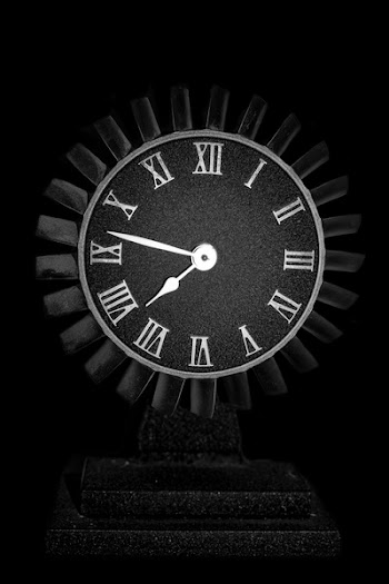 Round Black Wooden Analog Table Clock on Black Surface
