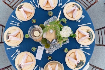 Round Blue Table With Plates and Cutleries on Top View Photo